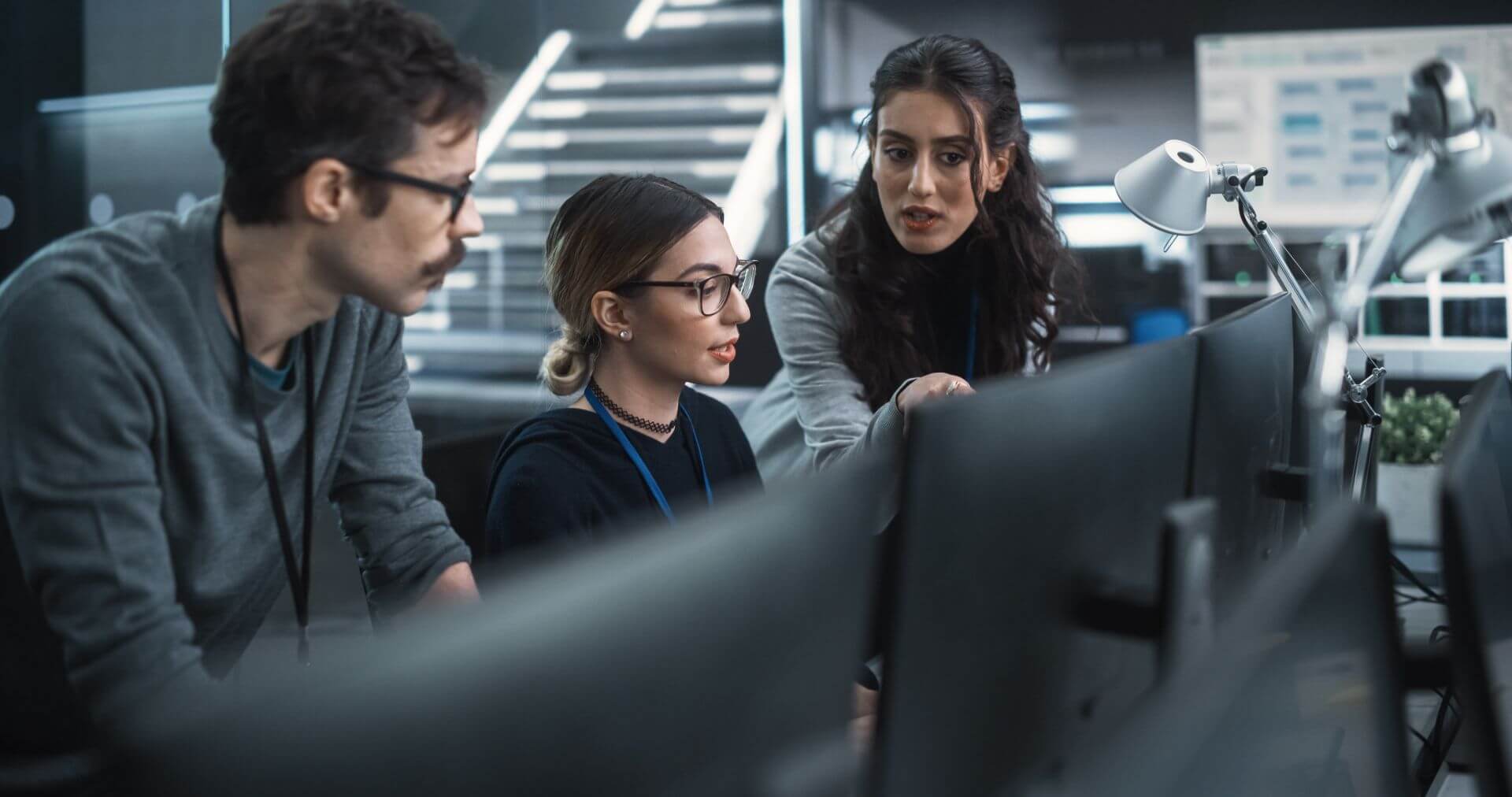 Three People in An Office Setting Working Together to Provide IT Service