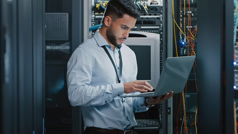 Man with laptop standing