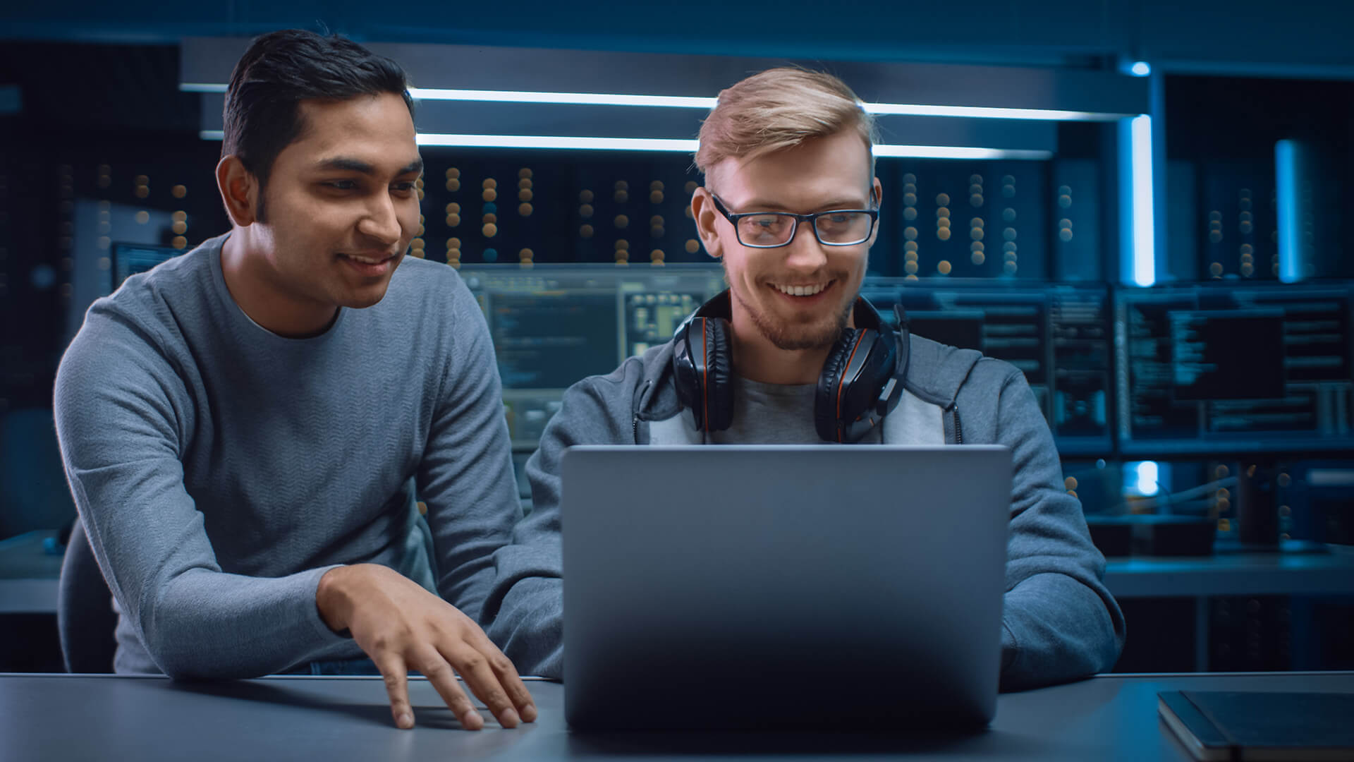 Two Men Monitoring Cloud Security Systems on a Laptop